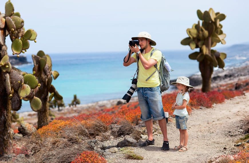 Kids snorkeling with tropical fish in clear waters of the Galapagos Islands family trip
