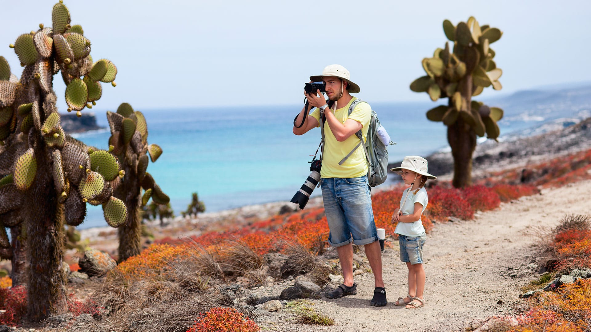 Kids snorkeling with tropical fish in clear waters of the Galapagos Islands family trip